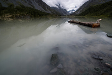 high mountain lake Akkem with mountains shrouded in clouds