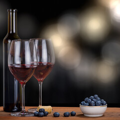 blueberry heap and red wine on blured background