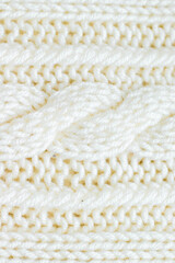 Fototapeta na wymiar knitting hobby knitted background of milky color with a pattern