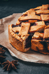 Freshly baked homemade pie with berries on a black background.