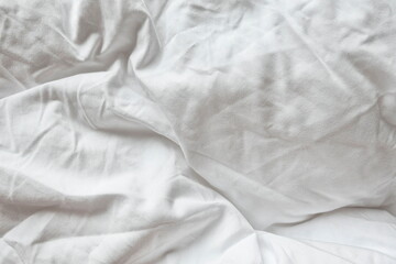 Obraz premium White Natural Cotton Sheet Bed Material Close-up. Unmade Hotel Bed Texture. Crumpled Messy Blanket In Home Bedroom.