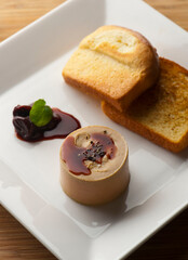 Pate or foie gras. Classic French bistro appetizer delicacy, served with a toasted buttery baguette.
