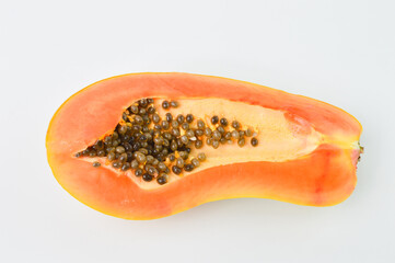 Half cut ripe papaya with seed on white background. Top view.