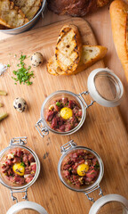 Steak tartare. Classic American restaurant or French bistro appetizer classic. Steak diced, mixed with eggs, red onions, olive oil, lemon juice, garlic and capers. Served with garlic bread.