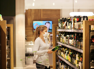 supermarket shopping, face mask,Woman choosing a dairy products at supermarket.