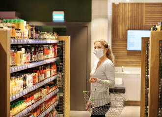 supermarket shopping, face mask,Woman choosing a dairy products at supermarket.