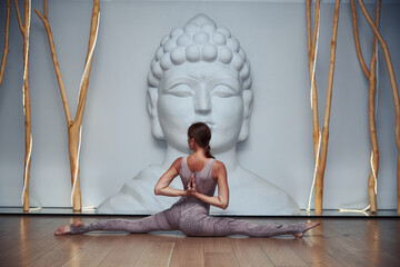 Young Woman Doing Yoga Exercise in Studio.