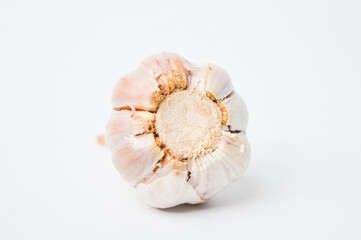 Rotten ripe garlic damaged bitten by insect and worm on a white background.