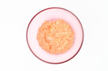 Top view of spicy fermented durian or popularly known as sambal tempoyak in a purple bowl over white background. 