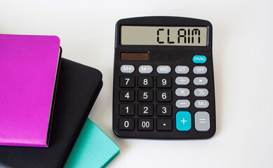 Claim text calculator and colored notepads on white background