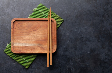 Wooden plate and chopsticks for your sushi and maki © evgeeenius