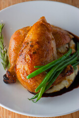 Chicken pan seared in garlic, butter, shallots and white wine. Classic fine dining cuisine. Served with steamed vegetables, broccoli carrots cauliflower, garnished with lemons and Italian parsley.