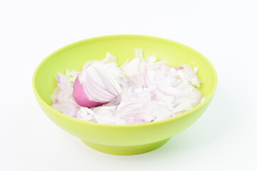 Sliced fresh white onions in a green bowl isolated on a white background. Side view.