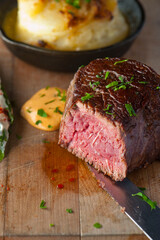 Steak and potatoes. Grade A grass fed angus beef steaks. Tenderloin, filet mignon, New York strip, bone in rib-eye grilled medium rare on outdoor wood-fired grill. Classic American steakhouse entree.