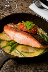 Salmon steaks. Salmon saut&eacute;ed in organic butter, garlic and served with jumbo lump crab cake, cauliflower, broccoli and potatoes. Classic American restaurant or French bistro entree favorite.