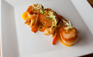 Scallops. Sautéed scallops seared in butter, garlic, shallots, red wine, tarragon, salt and pepper and served with toasted baguettes. Classic French bistro entree.