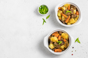 Traditional roast and potatoes in pots. Top view, copy space.