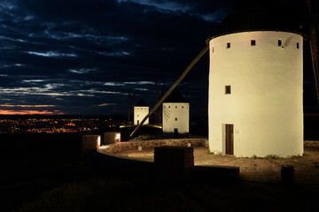 Exterior view of windmills in the landscape in spring at dusk in the Alcazar de San Juan, Ciudad Real, Spain