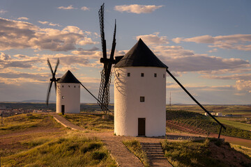 Exterior view of windmills on landscape in spring in Alcazar de San Juan, Ciudad Real, Spain