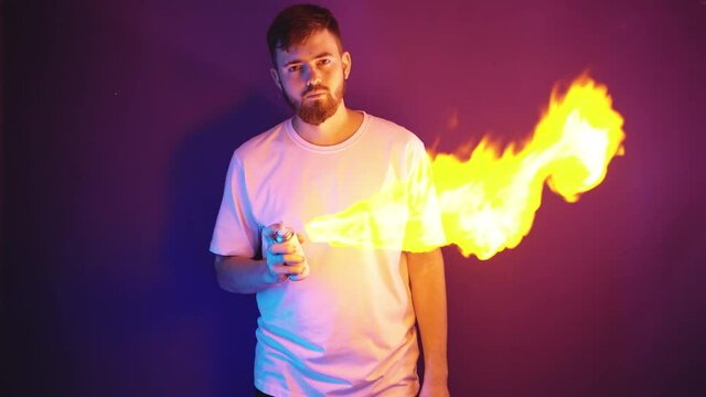 A man in a white T-shirt holds a gas cylinder in his hands