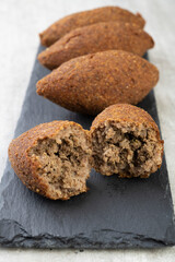 Traditional arabic fried kibbeh over stone board. Typical brazilian snack