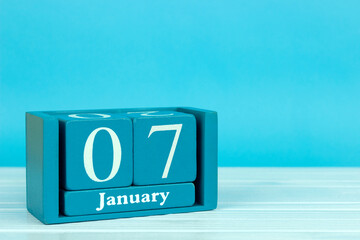 wooden calendar with the date of December 7 on a blue wooden background