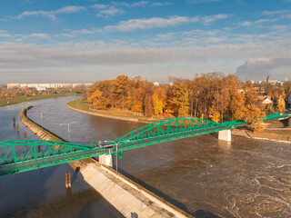 Fototapeta premium Green bridge to the Bolko island in Opole in autumn scenery