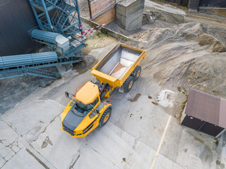 Aerial view of dumper truck in industrial pit for rock and sand mining. © Mario