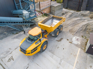Aerial view of dumper truck in industrial pit for rock and sand mining. © Mario