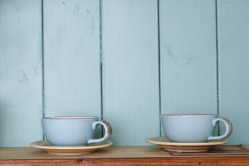 Kitchen shelf with mugs. Rustic background