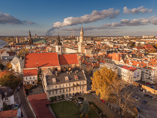 Obraz premium A drone view of the historic city with the market square, churches, town hall and the castle tower in Opole during sunset. Autumn in Silesia - Poland.