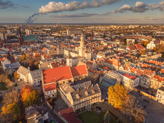 A drone view of the historic city with the market square, churches, town hall and the castle tower in Opole during sunset. Autumn in Silesia - Poland.