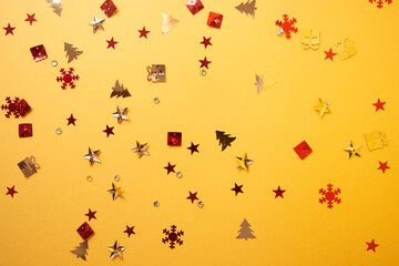 Christmas sparkles in the form of a Christmas tree, gifts, stars on a yellow background. High quality photo