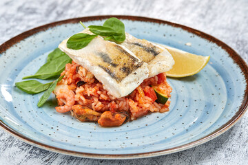 white fish with rice and vegetables