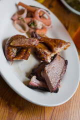 Barbecue catering platter with variety of meats. Traditional Texas BBQ: Beef brisket, beef ribs, pork ribs, sausage links, black pepper roasted chicken, and turkey served with homemade sauce.