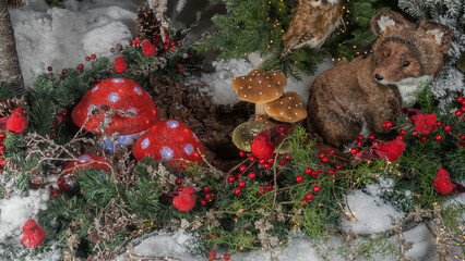 Christmas toys in the form of mushrooms, birds and small fox. Decorated christmas tree background. Happy new year concept.