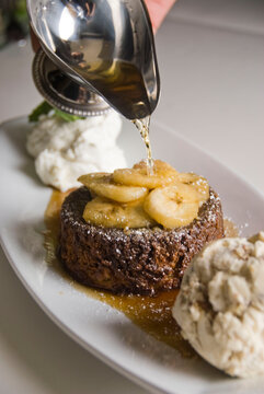 Bananas Foster Dessert. Classic Creole Or Cajun Dessert Favorite. Bananas Sautéed In Butter And Caramelized Sugar And Served With Cookies, Whipped Cream, Cake, Ice Creams And Chocolate Syrup.