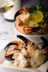 Stone crab claws. Colossal Crab claws served with lemons, spicy rémoulade sauce on top of a mixed green salad. Classic American restaurant or steakhouse appetizer or entree.