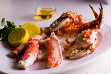 King crab or Dungeness legs . Jumbo Crab served with lemons, spicy rémoulade sauce on top of a mixed green salad. Classic American restaurant or steakhouse appetizer or entree.