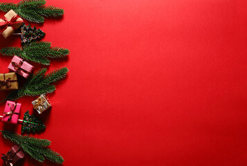 Christmas background with fir branches gifts and lollipops.