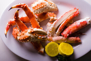 King crab or Dungeness legs . Jumbo Crab served with lemons, spicy rémoulade sauce on top of a mixed green salad. Classic American restaurant or steakhouse appetizer or entree.