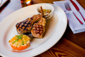 Lamb Chops. Grass-fed lamb, grilled to a medium rare and served with a garlic herb butter sauce and paired with roasted potatoes and Brussels sprouts. Classic American steakhouse favorite. 