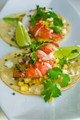 Fish or Lobster Tacos. Grilled lobster, mango slices, cheese, grilled bell peppers, onions, limes, cilantro and served on homemade corn tortillas. Classic Mexican or Tex-mex favorite.