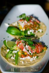 Fish or Lobster Tacos. Grilled lobster, mango slices, cheese, grilled bell peppers, onions, limes, cilantro and served on homemade corn tortillas. Classic Mexican or Tex-mex favorite.