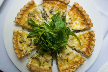 Quiche. Farm fresh eggs mixed with spinach, bacon, ham, sausage, cheese, vegetables poured in a pie crust and baked. Classic American restaurant or French Bistro breakfast or brunch favorite.