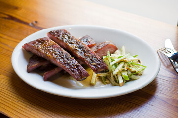 Pork ribs, barbecue style. Classic Traditional Texas Smokehouse favorite menu item: Baby Back pork ribs. Slow cooked in seasoned smoker over mesquite wood chips covered in homemade bbq sauce. 