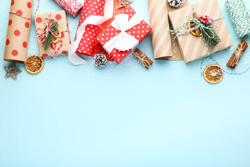 Fototapeta na wymiar Gift boxes with ornaments on blue background