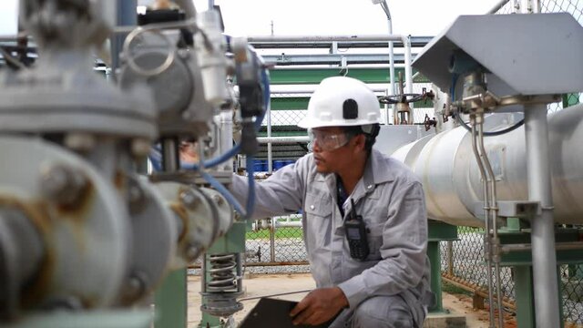 Field workers are inspecting the equipment, measuring and control equipment of the supply station for the industrial plant. Petroleum oil and refinery plant