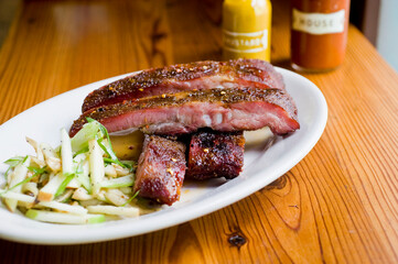 Pork ribs, barbecue style. Classic Traditional Texas Smokehouse favorite menu item: Baby Back pork ribs. Slow cooked in seasoned smoker over mesquite wood chips covered in homemade bbq sauce. 