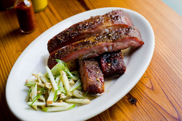 Pork ribs, barbecue style. Classic Traditional Texas Smokehouse favorite menu item: Baby Back pork ribs. Slow cooked in seasoned smoker over mesquite wood chips covered in homemade bbq sauce. 